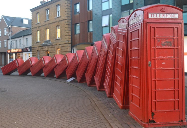 Red phone boxes tipping over in Kingston upon Thames, UK