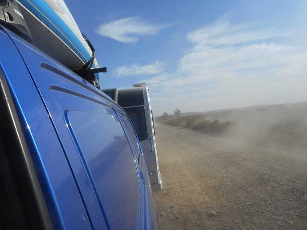 Showing a caravan being towed through a cornfield