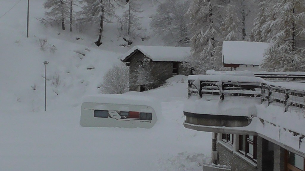 Caravan half buried in the snow