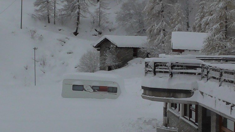 Caravan half buried in the snow
