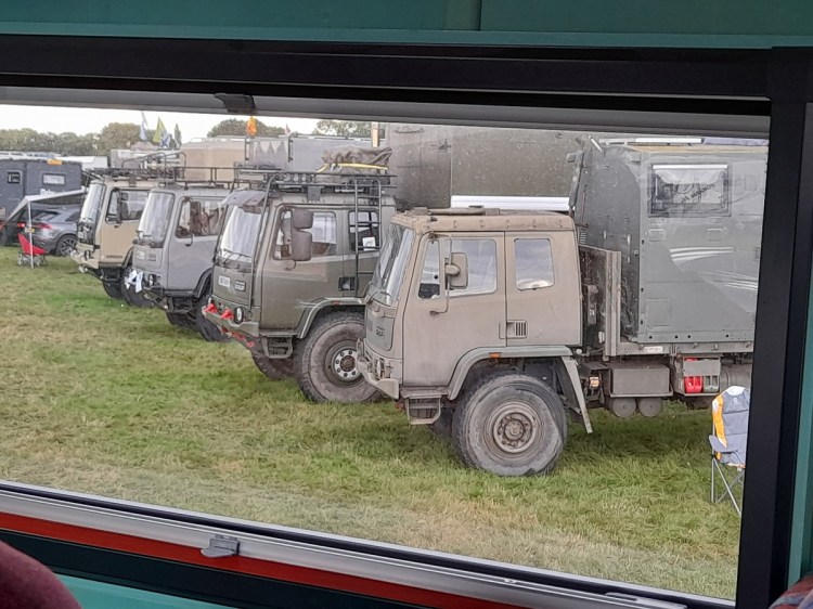 A view from our truck. The Beast's window at the overland show of a row of DAF army truck camper conversions