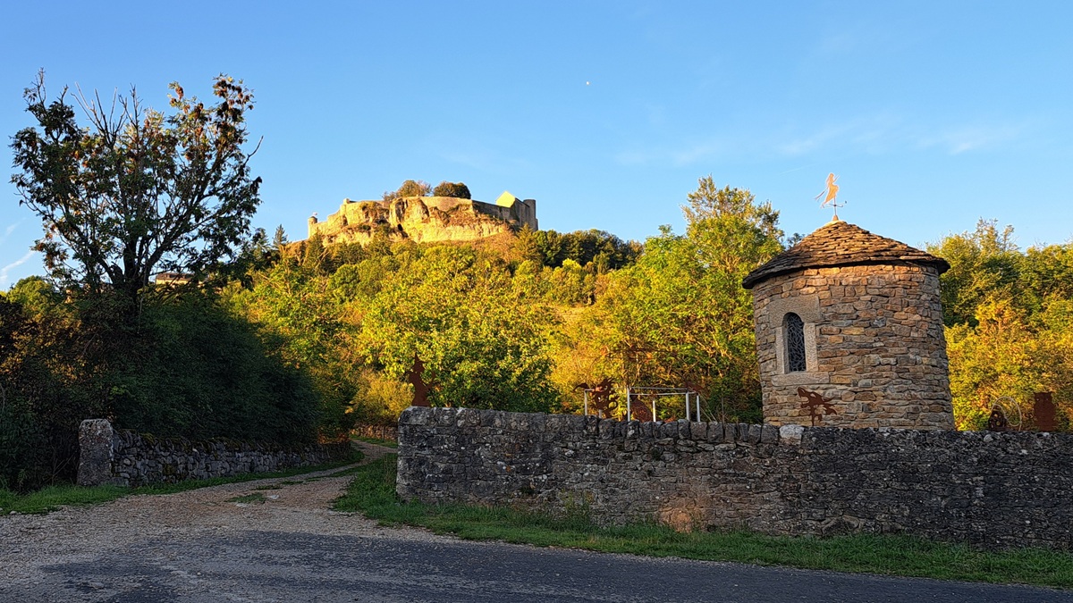 The castle at Sévérac-le-Château or Sévérac d’Aveyron viewed from the foot of the hill at sunset