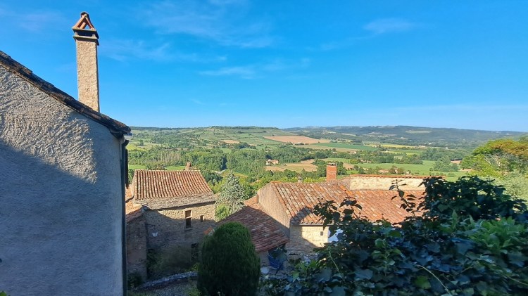 Vuew over terracotta rooftops out to the patchwork of fields below Cordes-sur-Ciel, France