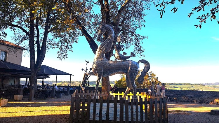 Unicorn sculpture in the shade of chestnut trees in Cordes-sur-Ciel