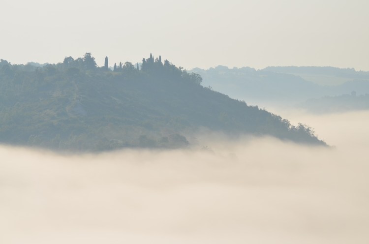 Clouds pooling beneath Cordes-Sur-Ciel showing how it got its name