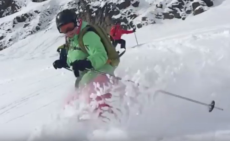 Author Jacqueline Lambert skiing off piste, a closeup with powder flying