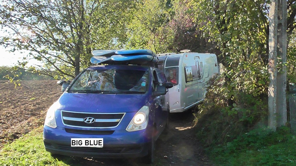 Jacqueline Lambert's van Big Blue towing Caravan Kismet along a footpath