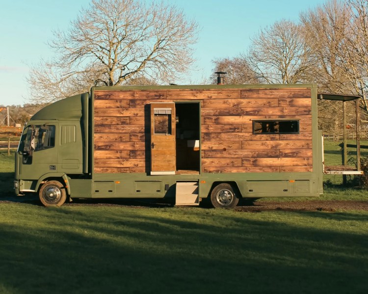 Image of wood pannelled overland truck which is being raffled at the Overland SHow you can win it for £1 per entry